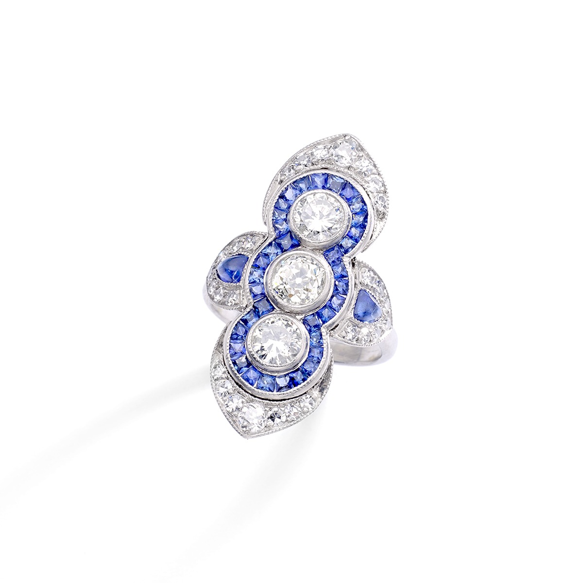 Art Deco Three Stones Diamond surrounded by calibrated Sapphire on Platinum Ring. Indian design inspiration as very often Art Deco period was influenced by various oriental cultures.