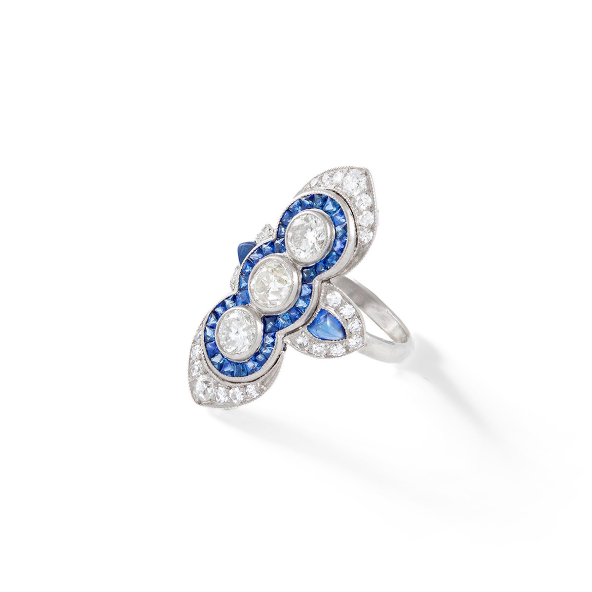 Art Deco Three Stones Diamond surrounded by calibrated Sapphire on Platinum Ring. Indian design inspiration as very often Art Deco period was influenced by various oriental cultures.