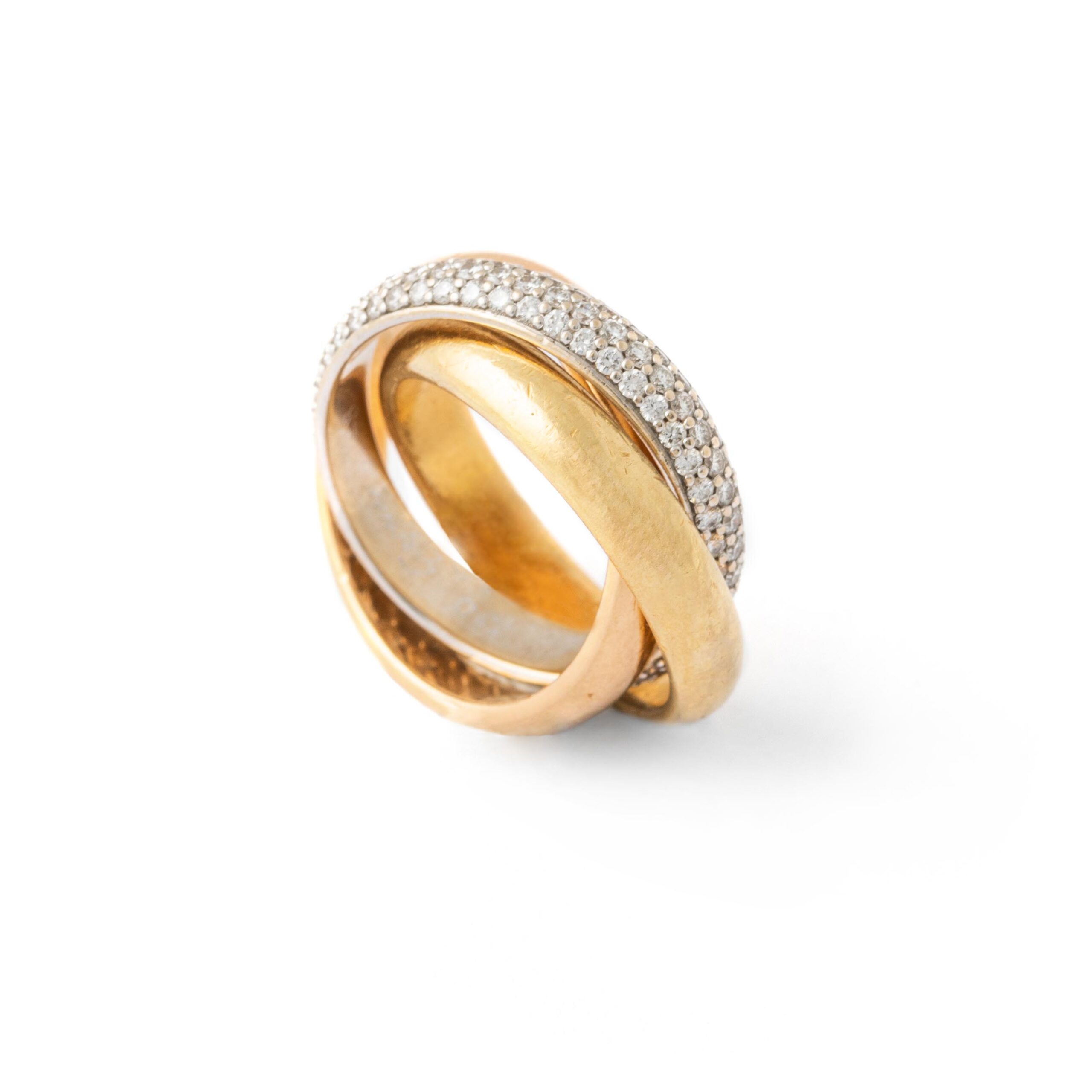 A classic Cartier diamond trinity ring set in 18k yellow